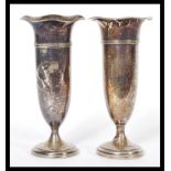 A pair of Edwardian early 20th Century silver hallmarked tulip vases, raised on pedestal bases