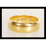 A 22ct gold gentleman's band ring being hallmarked. Size N, weight 6.8g