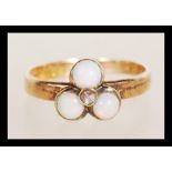 A 20th Century 9ct gold ring set with three opal cabochons. Marks rubbed but tests as 9ct. Weight