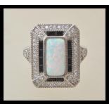 A stamped 925 silver Art Deco style ladies dress ring set with a central opal panel, set with cz and