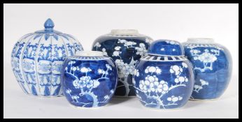 A selection of graduating 20th Century Chinese ginger jars, having hand painted cherry blossoms on a