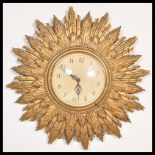 A vintage 20th Century Art Deco type sunburst starburst rising sun wall clock having a gilt