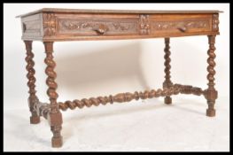 A 19th Century Victorian carved oak library sofa table writing desk raised on barley twist and block