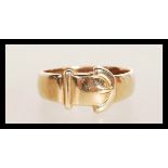 A hallmarked 9ct gold band ring in the form of a belt and buckle. Weighs 3.4 grams size M.