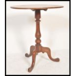 An early 19th Century Georgian mahogany folding tilt top wine occasional table raised on tripod