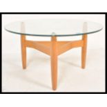 A retro  mid 20th Century teak framed coffee table raise on tapering supports united by stretchers