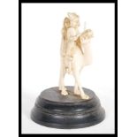A 19th Century Indian hand carved ivory figurine group depicting a man wearing robes and turban