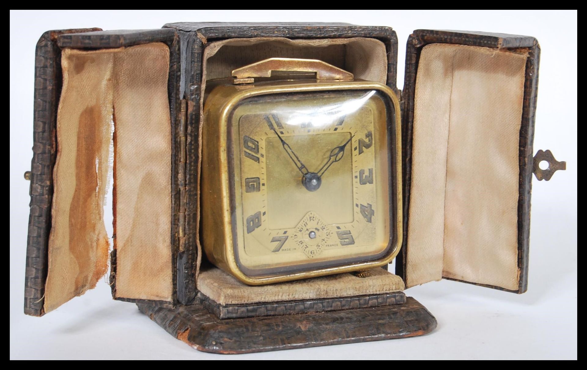 A vintage early 20th Century French Art Deco travel clock in fitted folding split door case. The