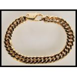 A large and heavy hallmarked 9ct gold gents curb link bracelet chain having a lobster claw clasp.