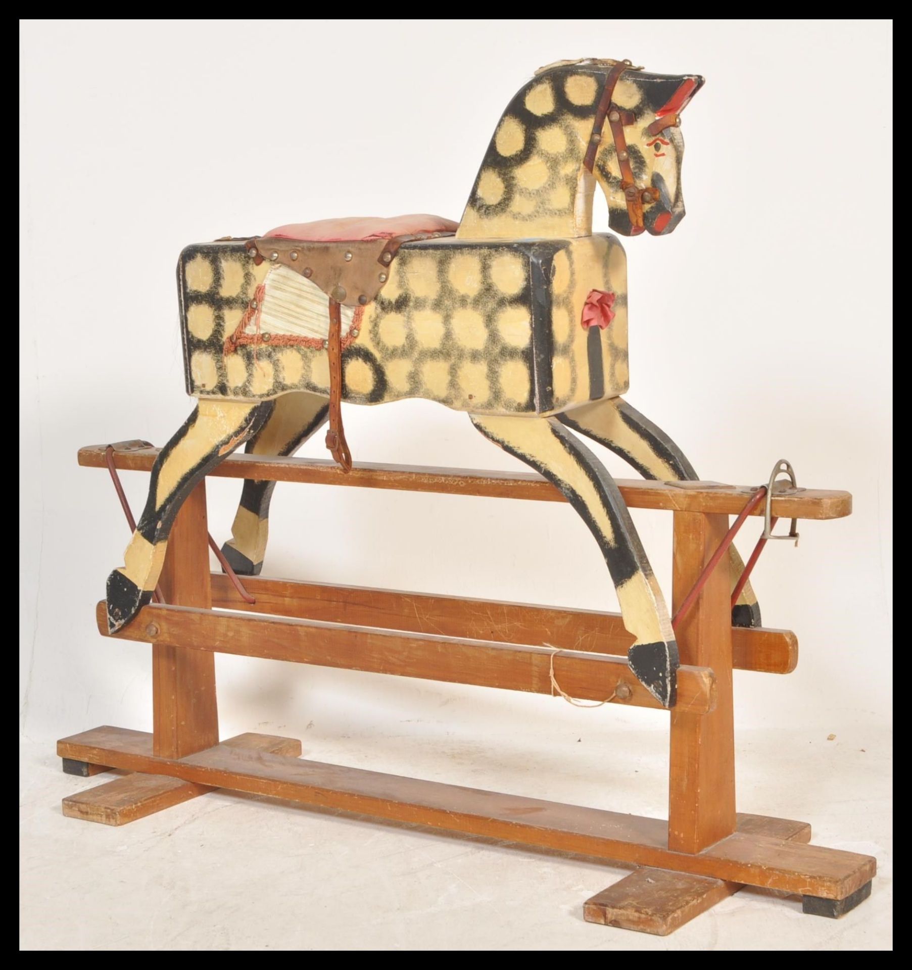 A mid 20th Century childs rocking horse, the rocking horse intricately carved throughout and