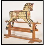 A mid 20th Century childs rocking horse, the rocking horse intricately carved throughout and