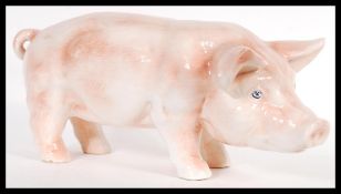 A large mid 20th Century butchers shop advertising point of sale ceramic pig, the pig on all fours