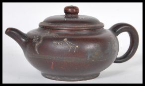 A 19th Century Chinese pottery Yixing teapot having hand painted decorated decoration depicting bats
