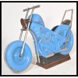 A vintage 20th Century fairground carousel ride in the form of a motorbike having blue moulded