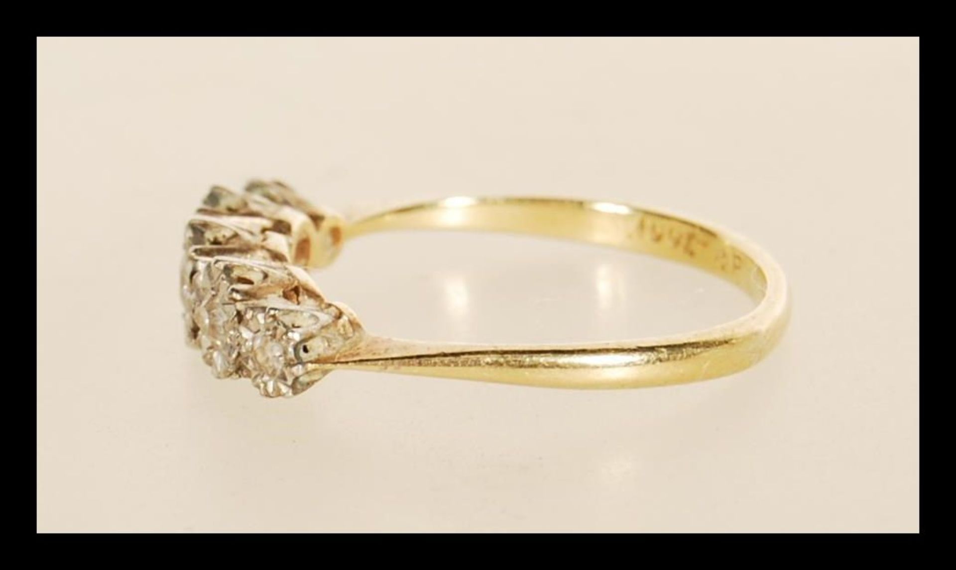 A stamped 18ct gold ring illusion set with five old cut diamonds. Weight 2.5g. Size O. - Bild 2 aus 4