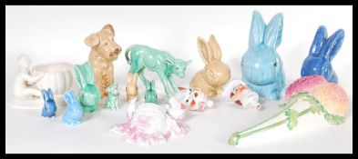 A collection of early 20th Century ceramic figurines to include a SylvaC green calf (no. 1431), a