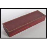 A vintage C & A Giuliano jewellery box having a red leatherette finish with gilt detailing, and a