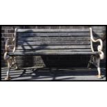 An early 20th Century large three seater cast iron and wooden slatted garden bench. Good weathered