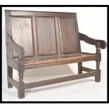 An 18th century country oak hall settle bench raised on block and turned legs with peripheral