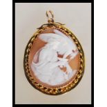 A 9ct gold hallmarked ladies shell cameo pendant. The central cameo depicting maiden and vulture