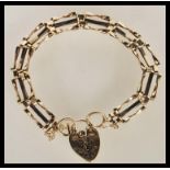 A 9ct gold 375 hallmarked ladies bracelet with heart shaped padlock and safety chain. Total weight