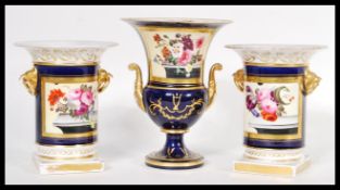 An early 19th Century set of three French porcelain urn garniture vases comprising of a pair