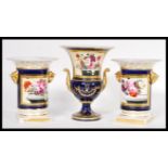 An early 19th Century set of three French porcelain urn garniture vases comprising of a pair