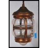 An early 20th Century hand blown and copper porch lantern complete with hanging chain and ceiling