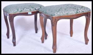 A pair of contemporary French fauteuil style carved mahogany dressing stools, overstuffed