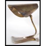 A vintage retro 20th Century Art Deco brass desk table lamp having shaped neck with adjustable