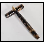 A vintage 20th Century Mentmore autoflow lever fill fountain pen having a 14k gold nib with brown