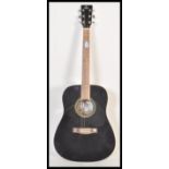 A Quintus German full size six string acoustic guitar having a lacquered black finish with striped