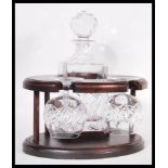 A 20th Century mahogany cased cut glass decanter and pair of matching brandy glasses tantalus set.