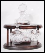A 20th Century mahogany cased cut glass decanter and pair of matching brandy glasses tantalus set.