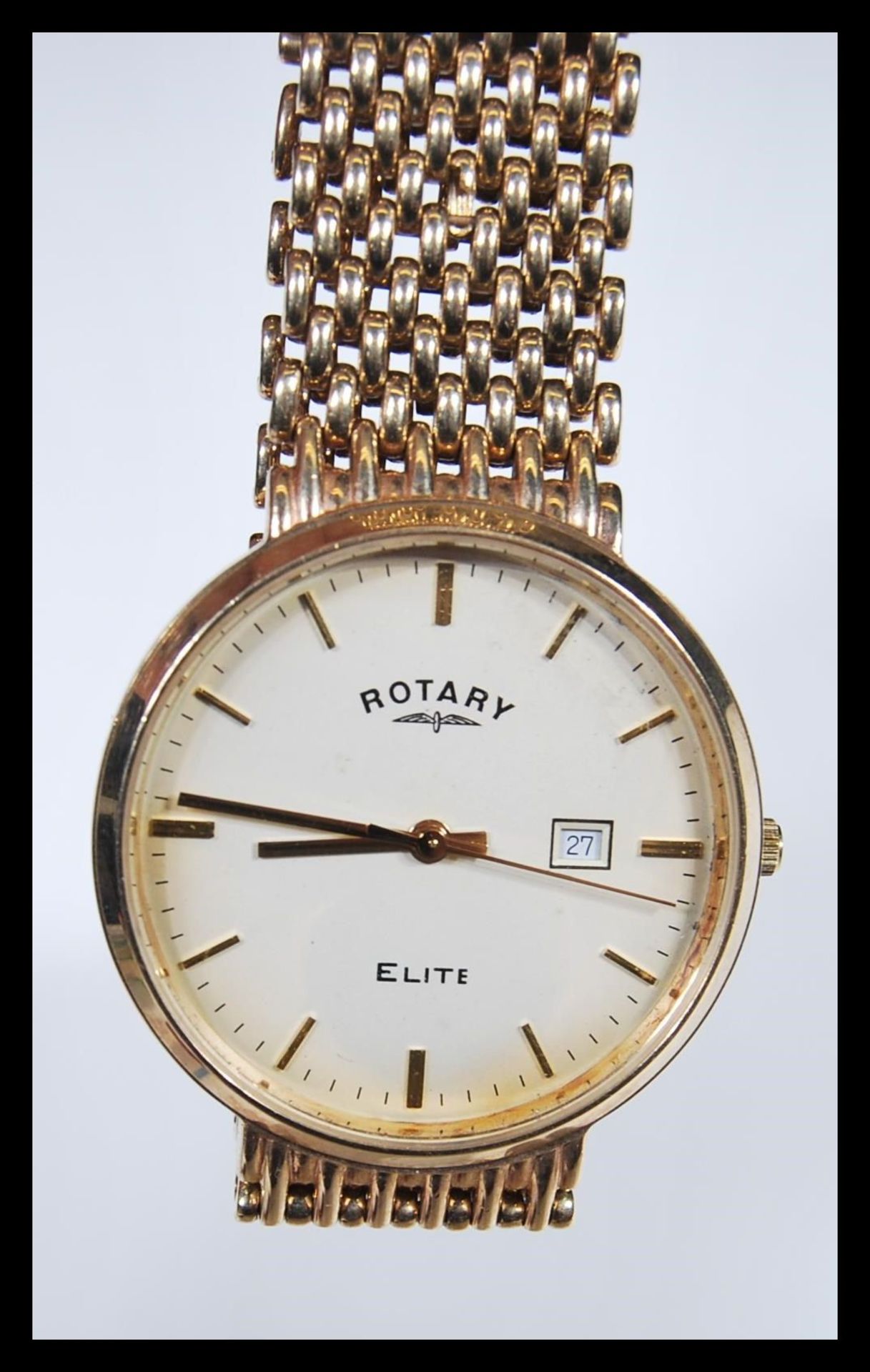A boxed Rotary Elite 9ct gold gents watch set to a 9ct gold mesh watch bracelet strap. The white
