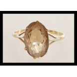 A 9ct gold ladies dress ring with inset large oval facet cut smoky quartz, weight 3.3g / Size Z1