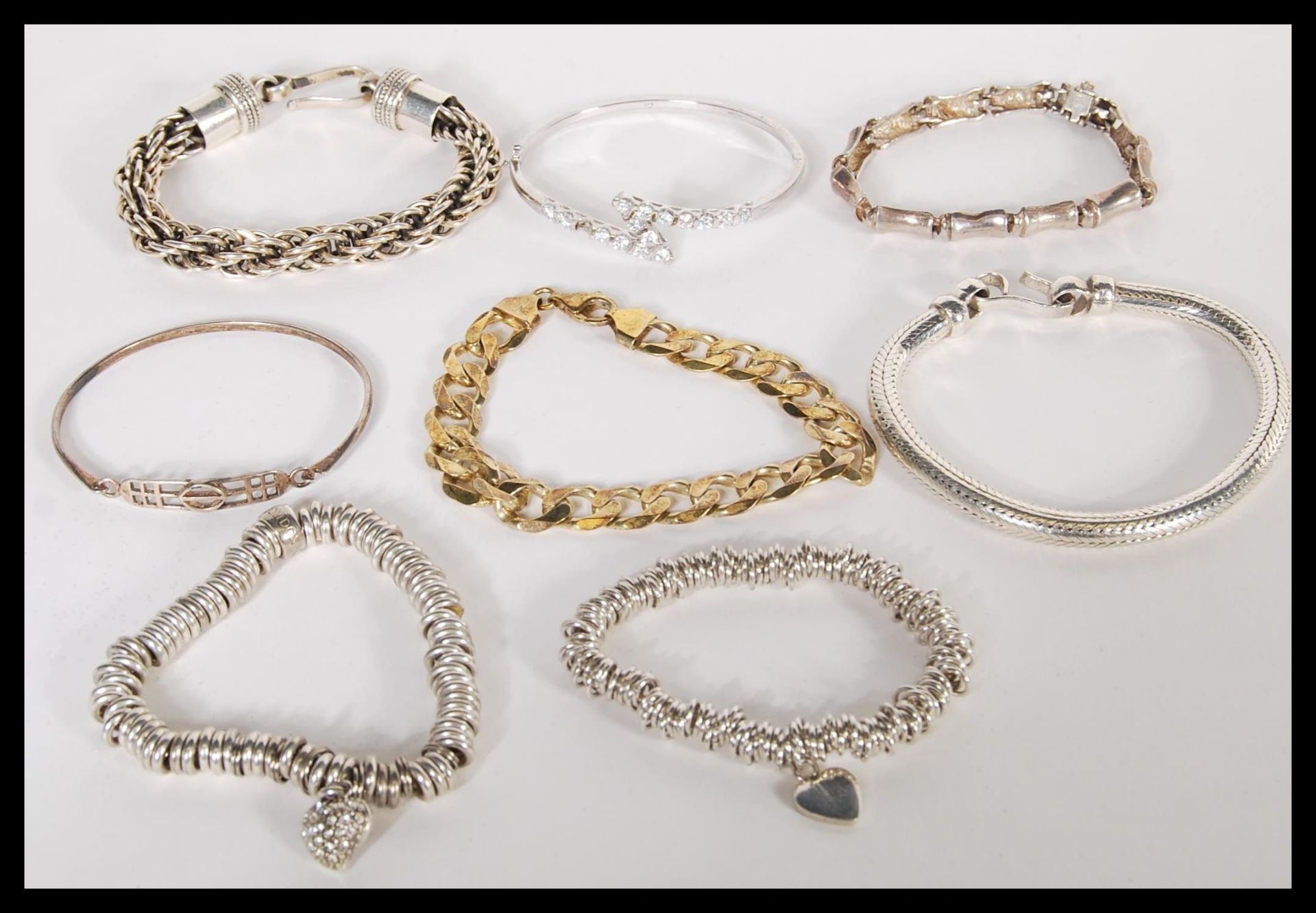 A good group of sterling silver bracelets to include a silver curb link example, large 925 twist