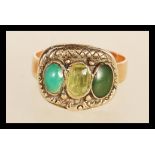 A 19th Century Victorian yellow metal gold ring set with differing three green stone cabochons