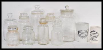 A collection of 19th Century Victorian and later glass kitchen storage / apothecary jars with lids
