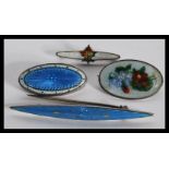 A group of four sterling silver and enamel set danish brooches in the Georg Jensen or Charles Horner