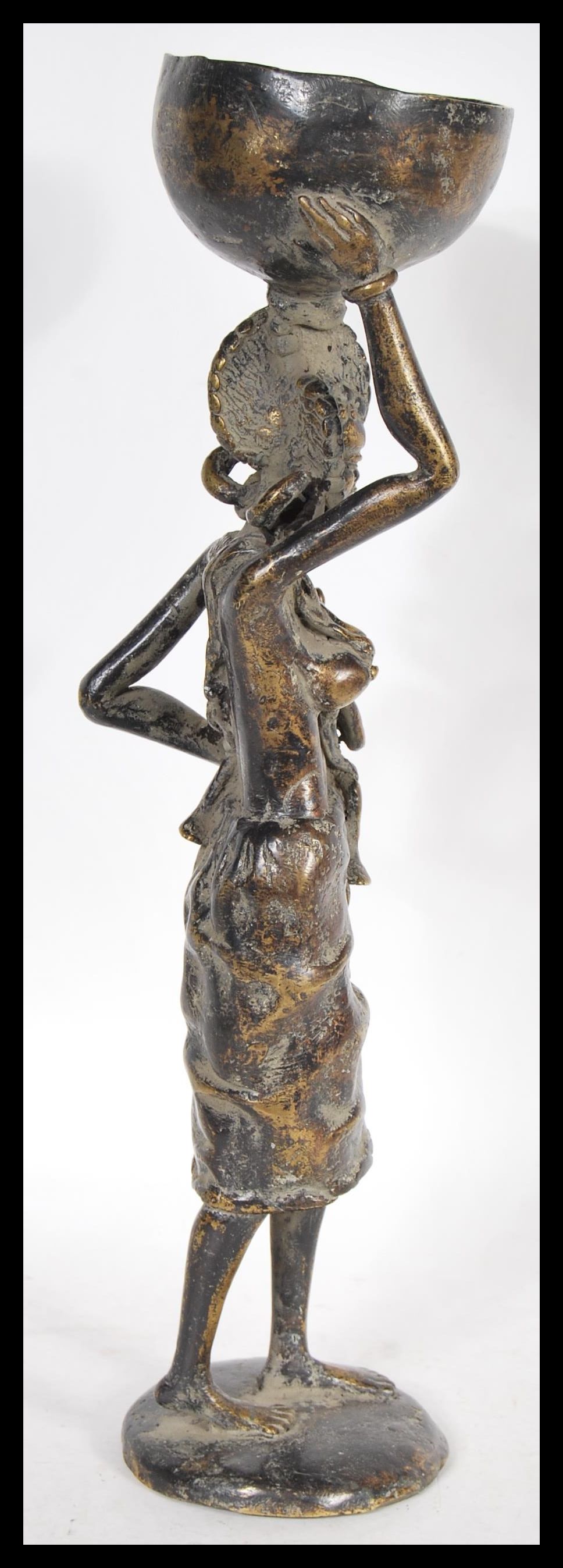 A 20th Century African fertility bronze figure, the figure raised on a circular base of a mother - Image 4 of 7