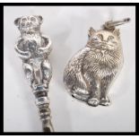 A hallmarked silver lace hook having a handle in the form of a bear along with a silver plated