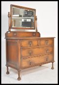 An early 20th Century Edwardian oak dressing table chest, swing mirror to top over two short drawers