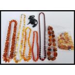 A collection of faux amber necklaces to include a cherry amber bakelite type bead necklace,