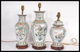 A collection of three 20th Century Chinese table lamps, decorated with panels depicting warriors