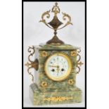 A 19th Century French Empire mantel clock having a green marble case. The white enamel face having