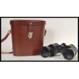 A pair of vintage Carl Zeiss Jena Jenoptem binoculars (10x50 W) in a brown leather case. Measures