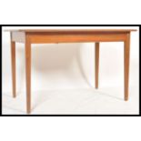 A vintage retro 20th Century teak Danish influence dining table. The extending dining table with