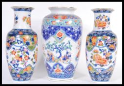 A 20th Century Chinese bulbous vase decorated with musicians and peonies throughout together with