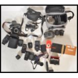 A collection of vintage 20th Century 35mm cameras and lenses to include a Pentax Super F1, Ashai
